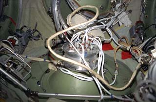 Center node view of cables, connections and hoses of the Russian designed hermaplate used to seal off the Spektr module.